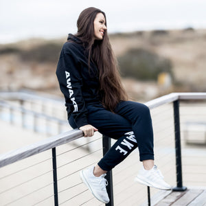 Beckah Shae Black Awake Hoodie and Joggers. Our best selling hoodie and jogger bundled in one set. The ‘Lion Awake Hoodie’ features a lion face graphic design on the back with the text "Awake" on the right sleeve. The 'Lion Awake Jogger' features pearl white graphics on a premium true black poly/cotton blend jogger that tapers around the leg.