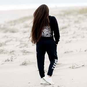 Beckah Shae Black Awake Hoodie and Joggers. The ‘Lion Awake Hoodie’ features a lion face graphic design on the back with the text "Awake" on the right sleeve. Custom Printed on a unisex black hoodie.