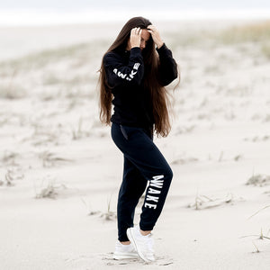 Beckah Shae Black Awake Hoodie and Joggers. The ‘Lion Awake Hoodie’ features a lion face graphic design on the back with the text "Awake" on the right sleeve. Custom Printed on a unisex black hoodie.