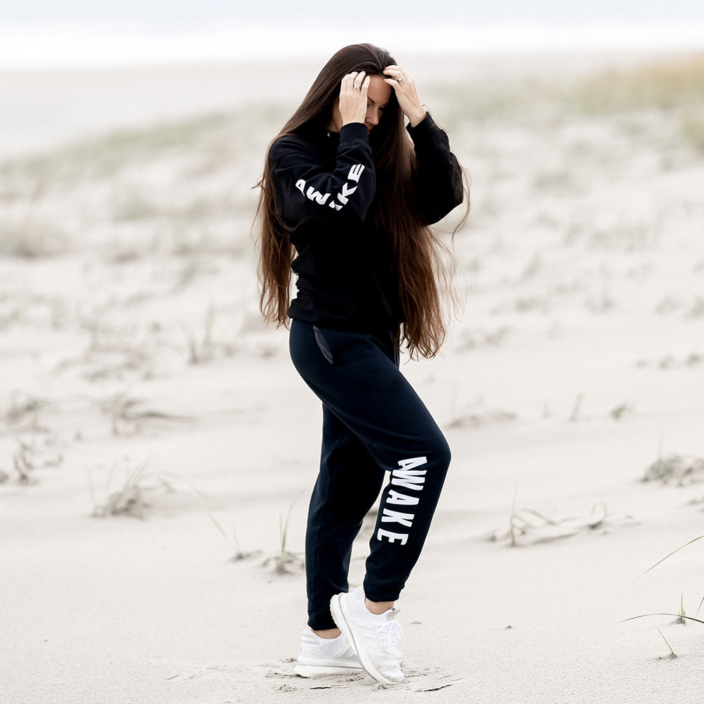 Beckah Shae Black Awake Hoodie and Joggers. The ‘Lion Awake Hoodie’ features a lion face graphic design on the back with the text 