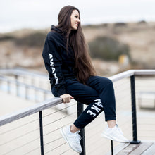 Load image into Gallery viewer, Beckah Shae Black Awake Hoodie and Joggers. Our best selling hoodie and jogger bundled in one set. The ‘Lion Awake Hoodie’ features a lion face graphic design on the back with the text &quot;Awake&quot; on the right sleeve. The &#39;Lion Awake Jogger&#39; features pearl white graphics on a premium true black poly/cotton blend jogger that tapers around the leg.