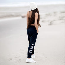 Load image into Gallery viewer, Beckah Shae Black Awake Joggers with a White Awake Beanie. The &#39;Lion Awake Jogger&#39; features pearl white graphics on a premium true black poly/cotton blend jogger that tapers around the leg.