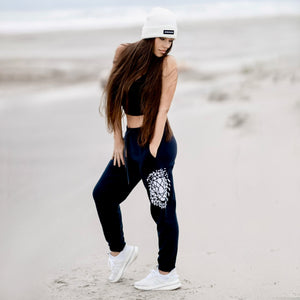 Beckah Shae Black Awake Joggers with a White Awake Beanie. The 'Lion Awake Jogger' features pearl white graphics on a premium true black poly/cotton blend jogger that tapers around the leg.