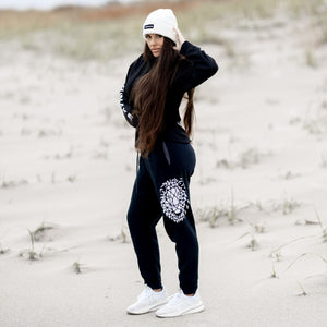 Beckah Shae Black Awake Hoodie and Joggers with a White Awake Beanie. Our best selling hoodie and jogger bundled in one set. The ‘Lion Awake Hoodie’ features a lion face graphic design on the back with the text "Awake" on the right sleeve. The 'Lion Awake Jogger' features pearl white graphics on a premium true black poly/cotton blend jogger that tapers around the leg.