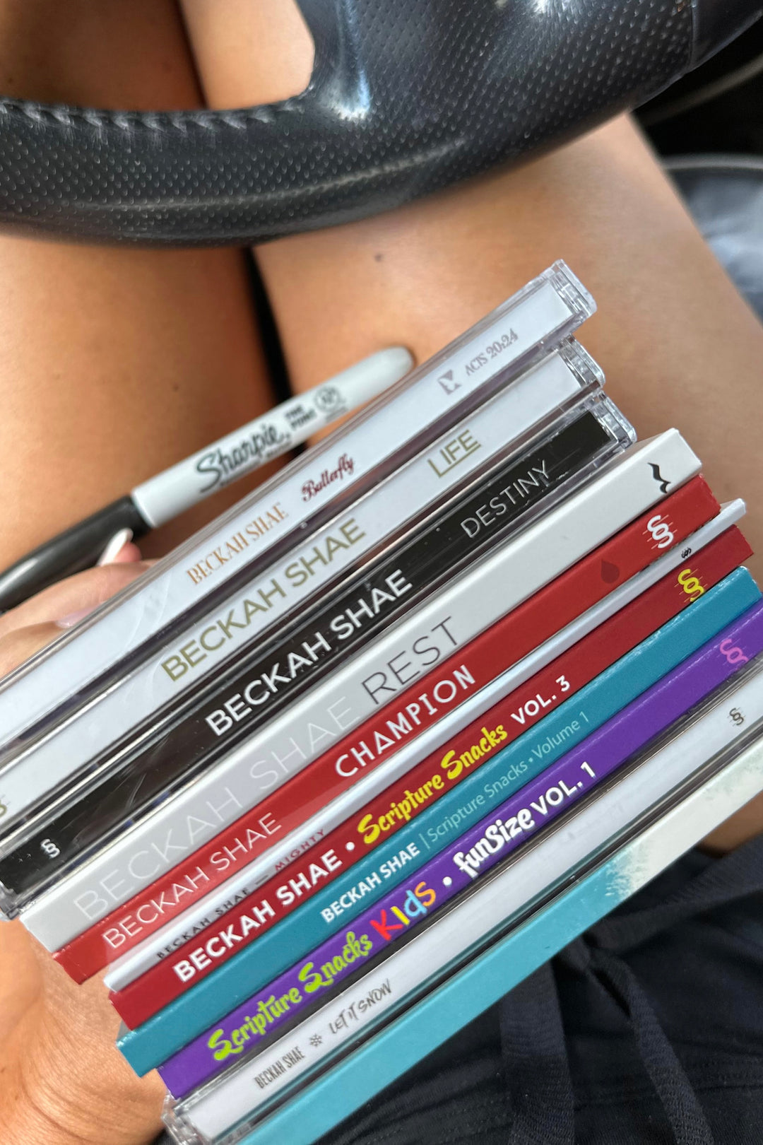 A stack of Beckah Shae CDs on Beckah’s lap.