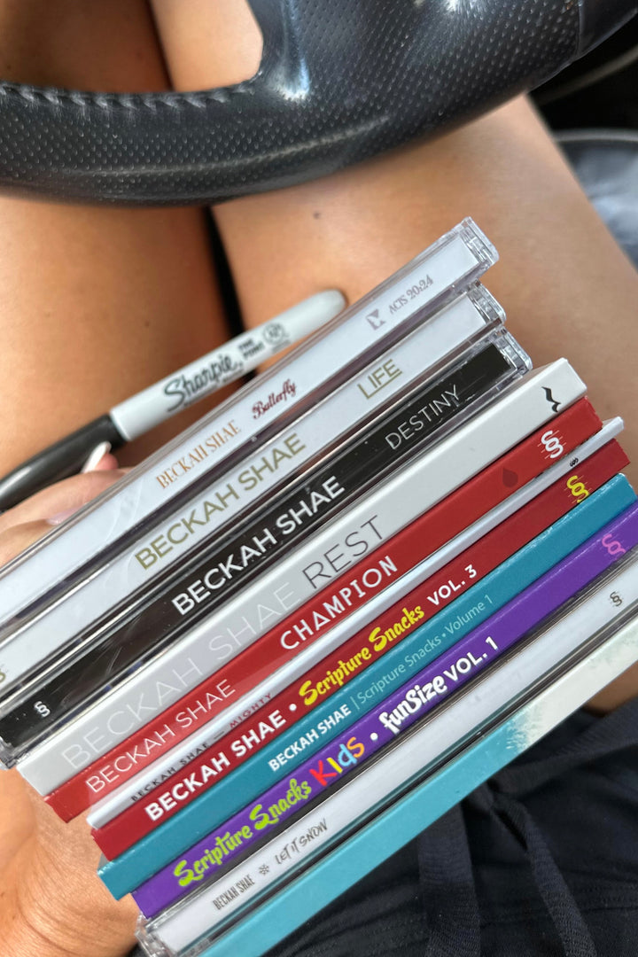 A stack of Beckah Shae CDs on Beckah’s lap.