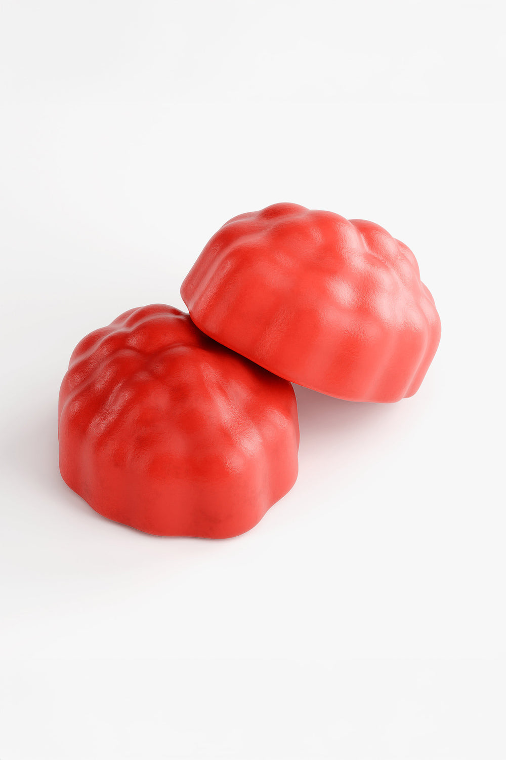 Close-up of two Hair Halo red gummies with a soft, fruit-like texture designed for daily hair nutrition.